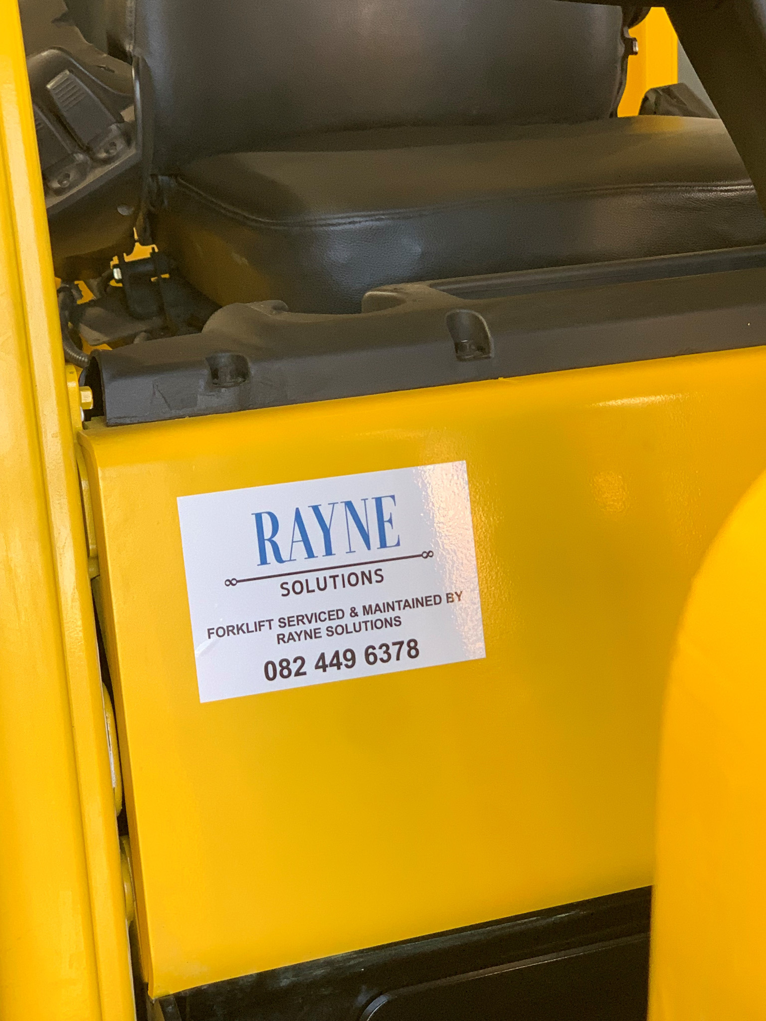 rayne sticker on yellow forklift